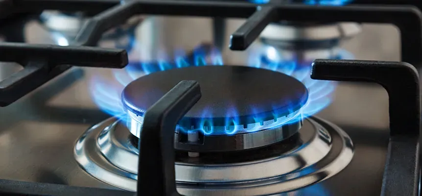 Kitchen burners lit with blue gas flame
