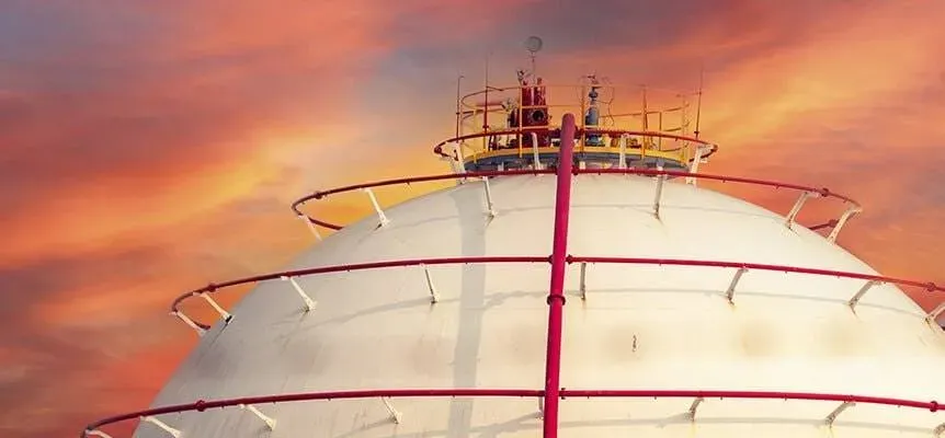 Spherical industrial gas tank at dusk