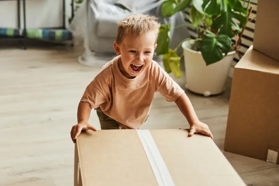 A child plays with a cardboard box