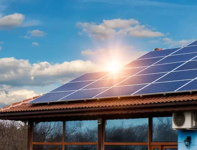 Image of technician with solar panel. You put the roof. We the revolution.